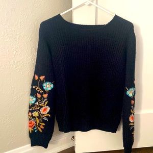 Woven Heart black knit sweater with sleeve detailing.